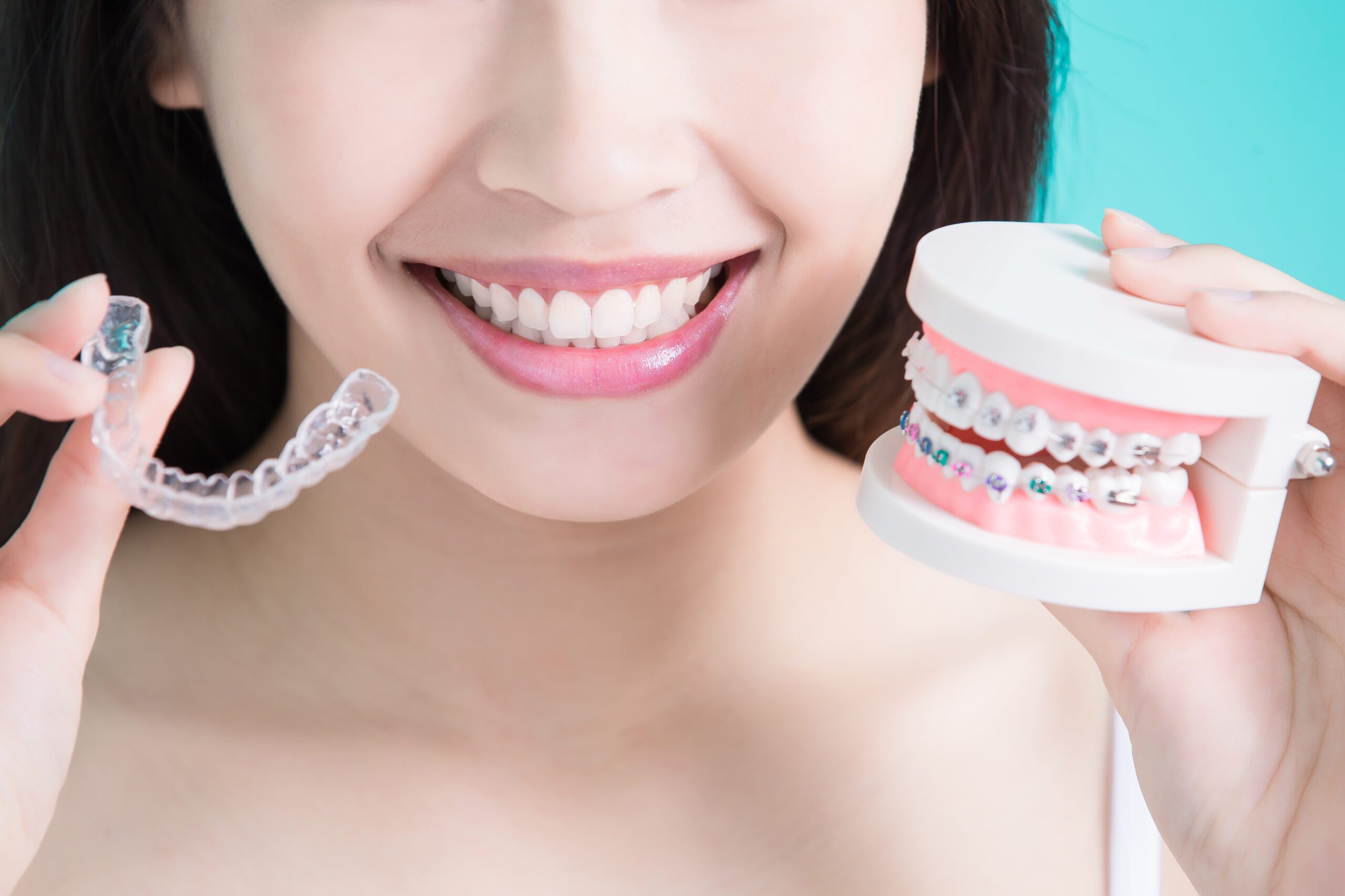 healthy dental concept woman choicce different brace on green background